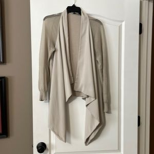 Taupe color, mesh sleeves, knit back. Dramatic front flare